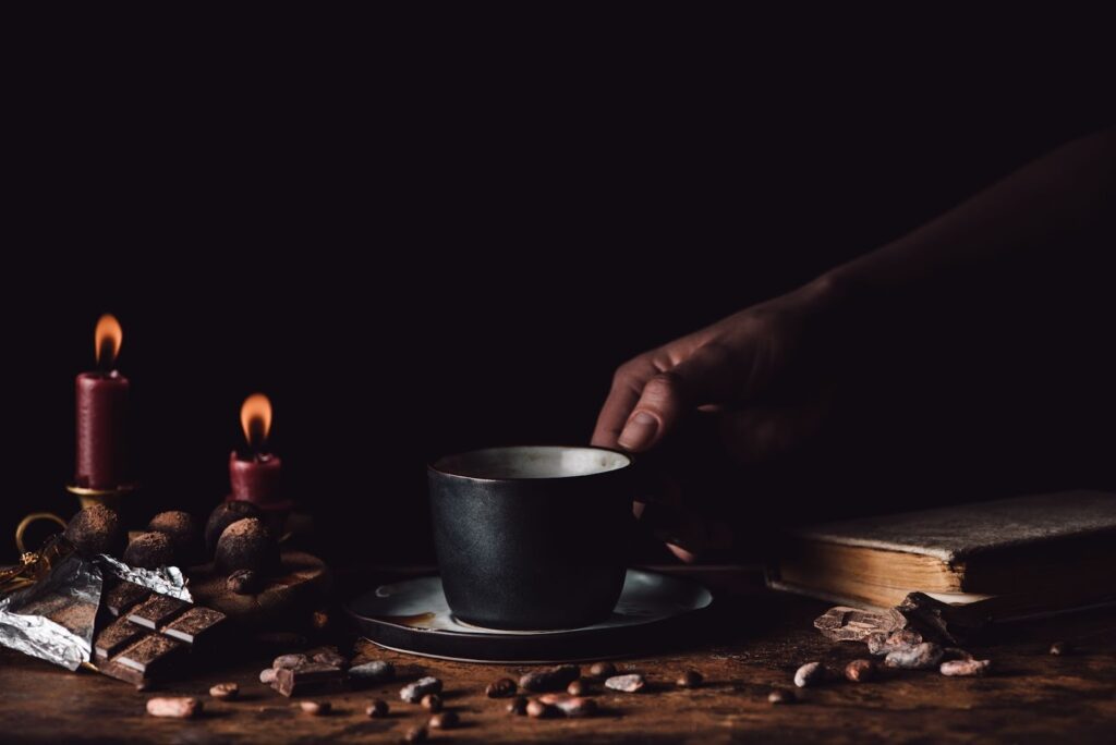 Close-up of a woman holding a cup of freshly brewed, steaming coffee